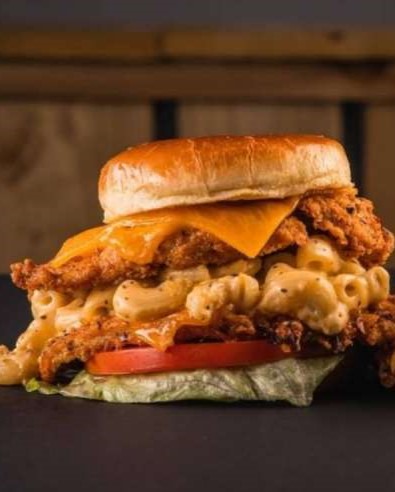The Burgerzzz in Airdrie fried chicken burger stacked with mac and cheese.