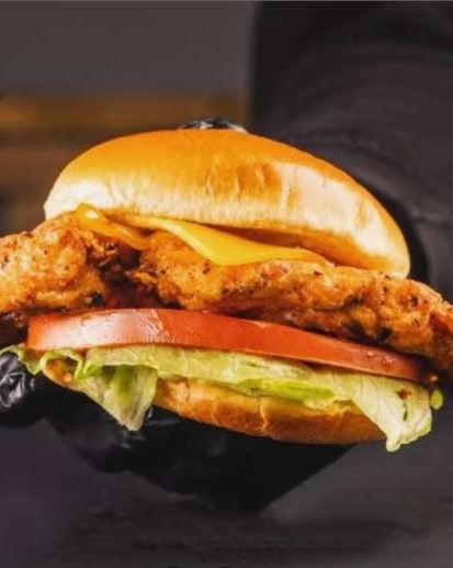 The Burgerzzz in Coatbridge fried chicken fillet sandwich with cheese, tomato, and lettuce.
